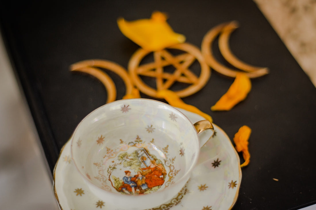 a tea cup and saucer sitting on a table