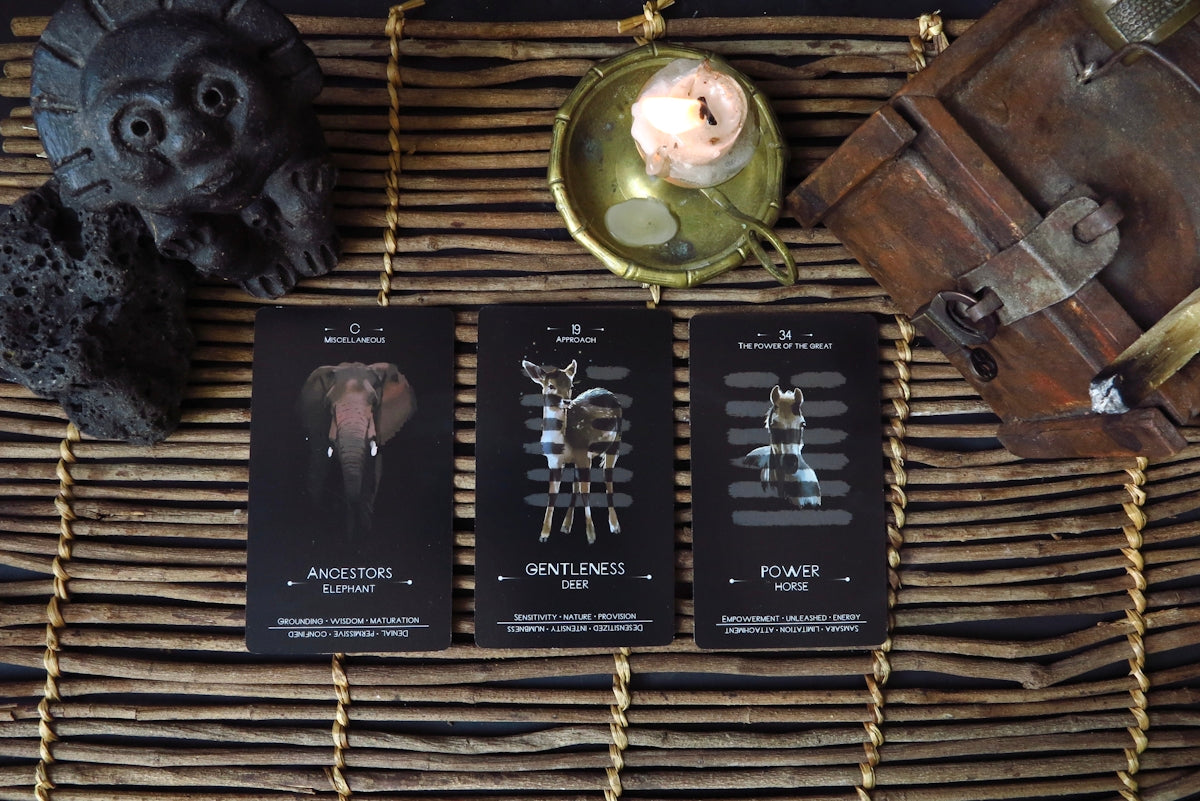 a wicker basket with three cards and a candle