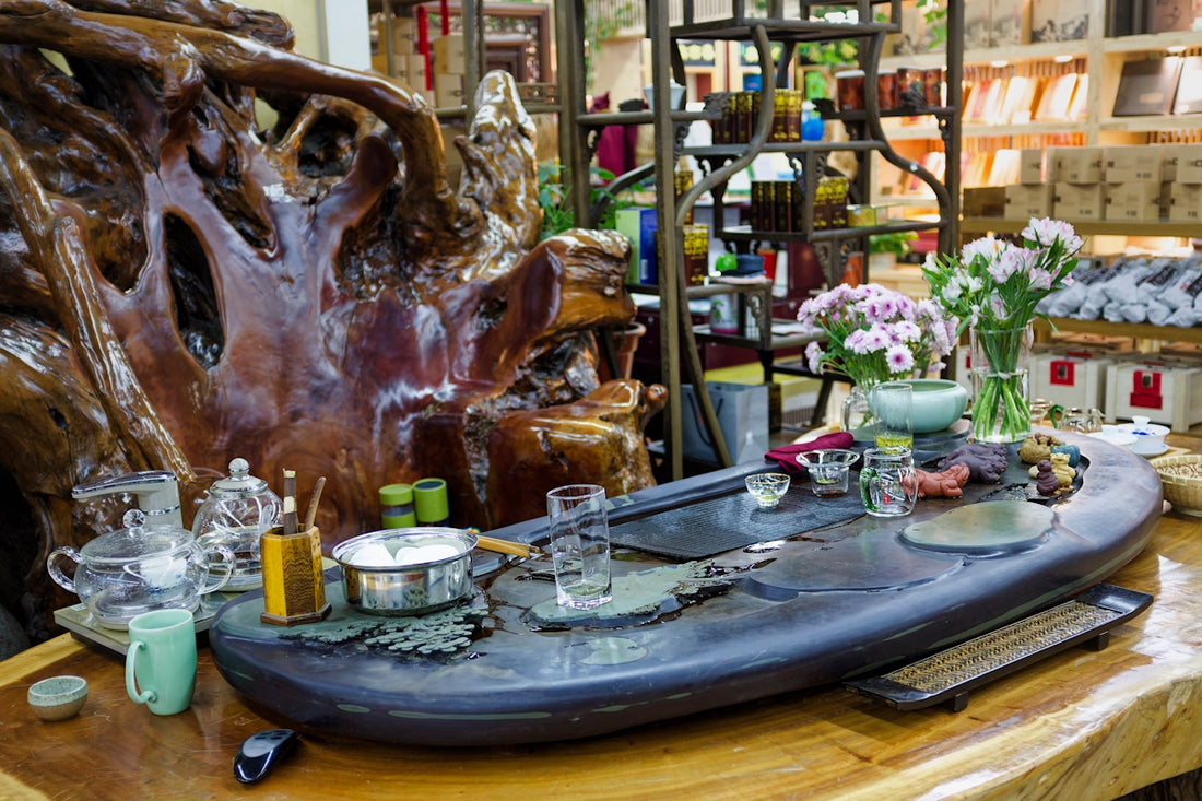 A wooden table topped with lots of dishes and vases