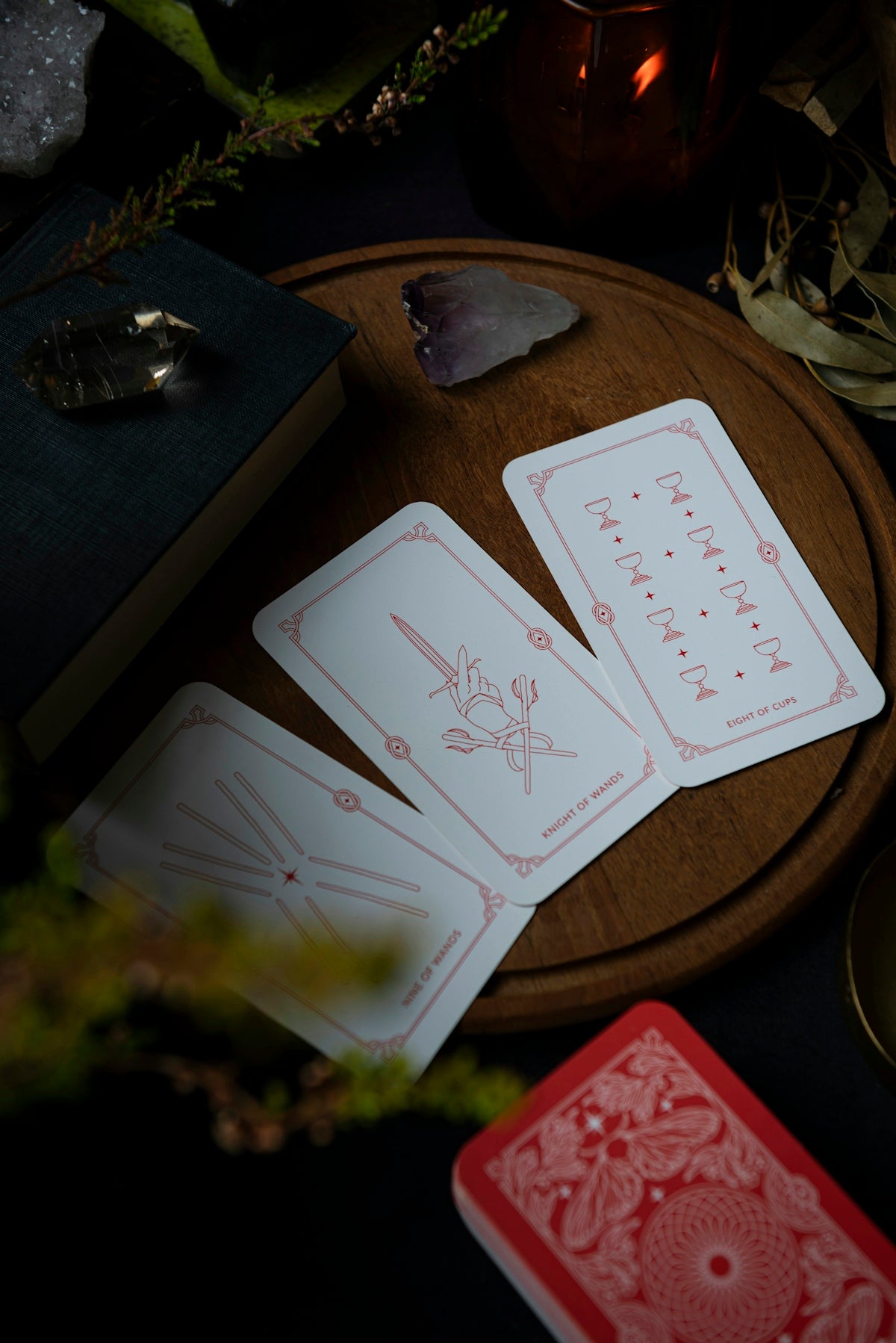 A table topped with cards and a candle
