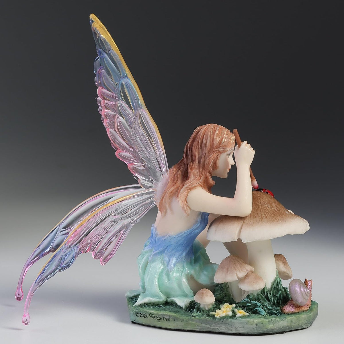 Chromatic Fairy Painting a Lady Bug Figurine