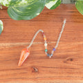 7 Chakra Faceted Carnelian Pendulum | | Wiccan Center