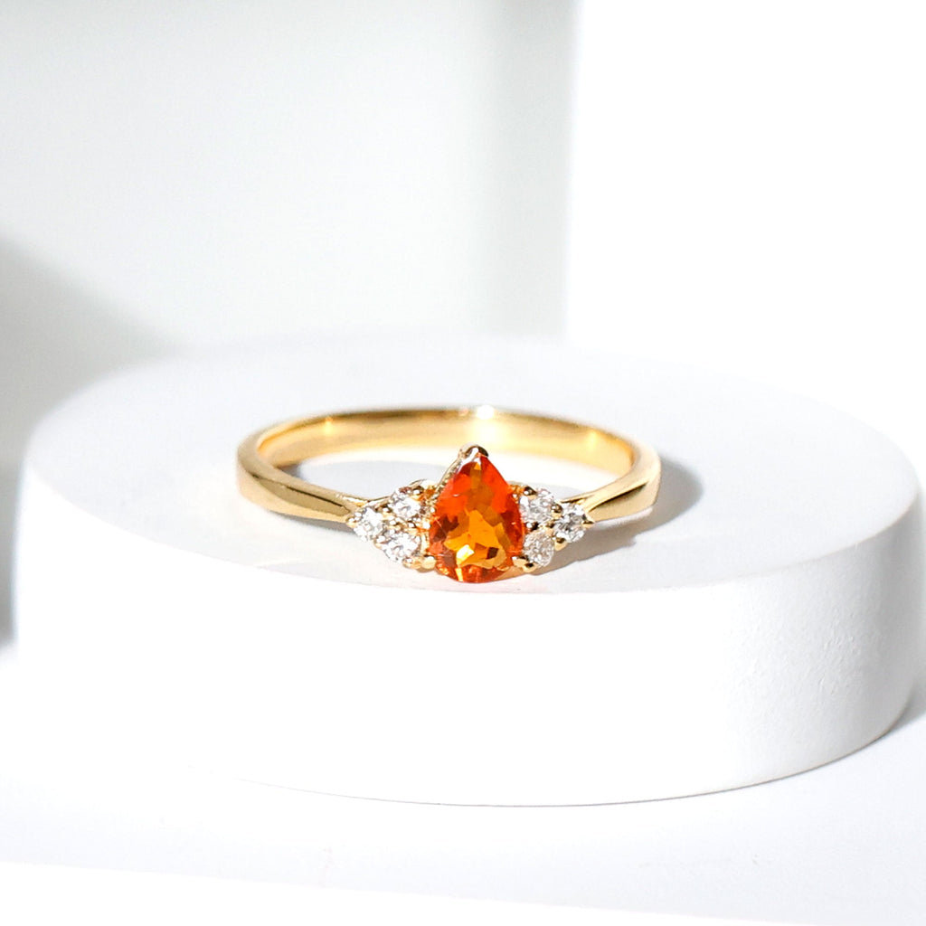 0.6 Carat Pear Shaped Fire Opal Engagement Ring with Diamond Trio