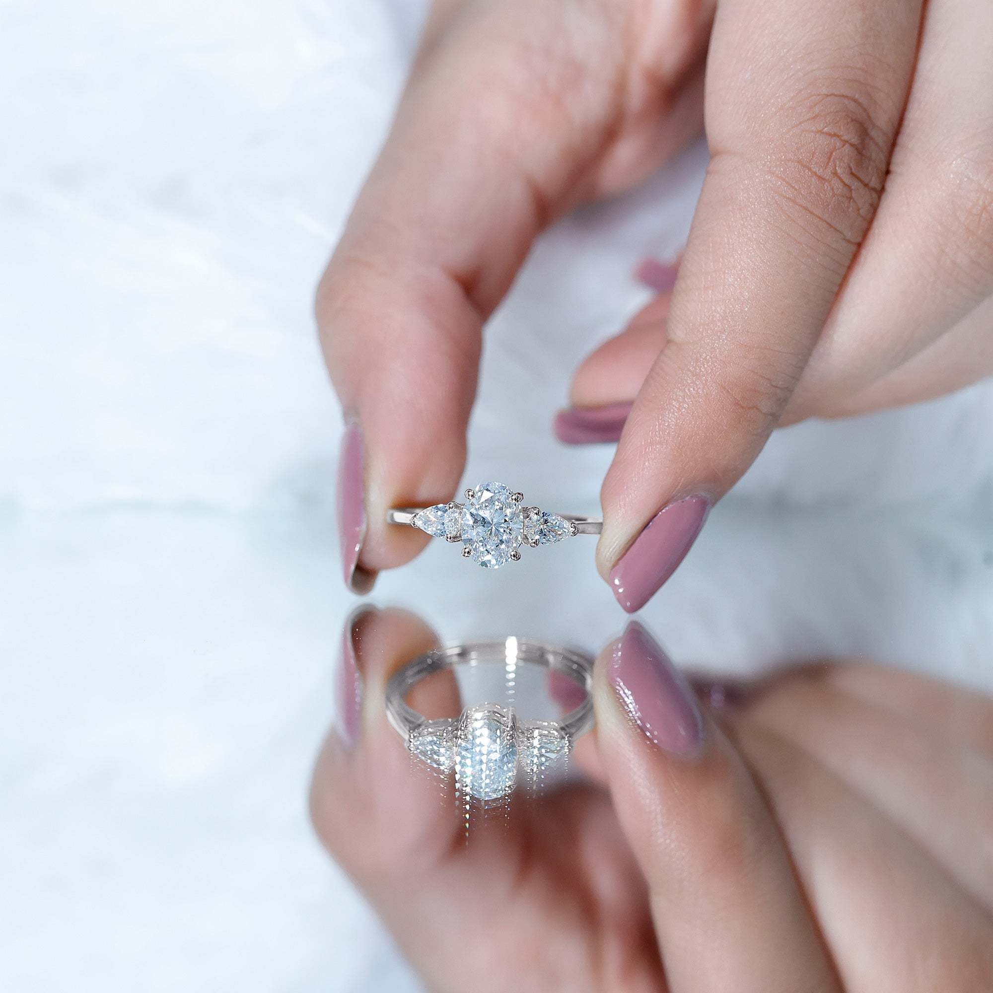 Oval and Pear Cut Moissanite Three Stone Engagement Ring