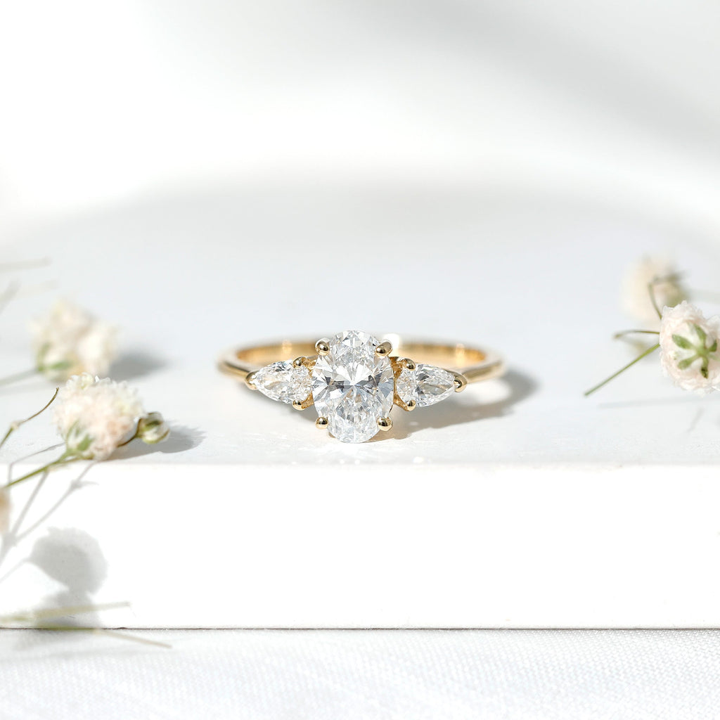 Oval and Pear Cut Moissanite Three Stone Engagement Ring