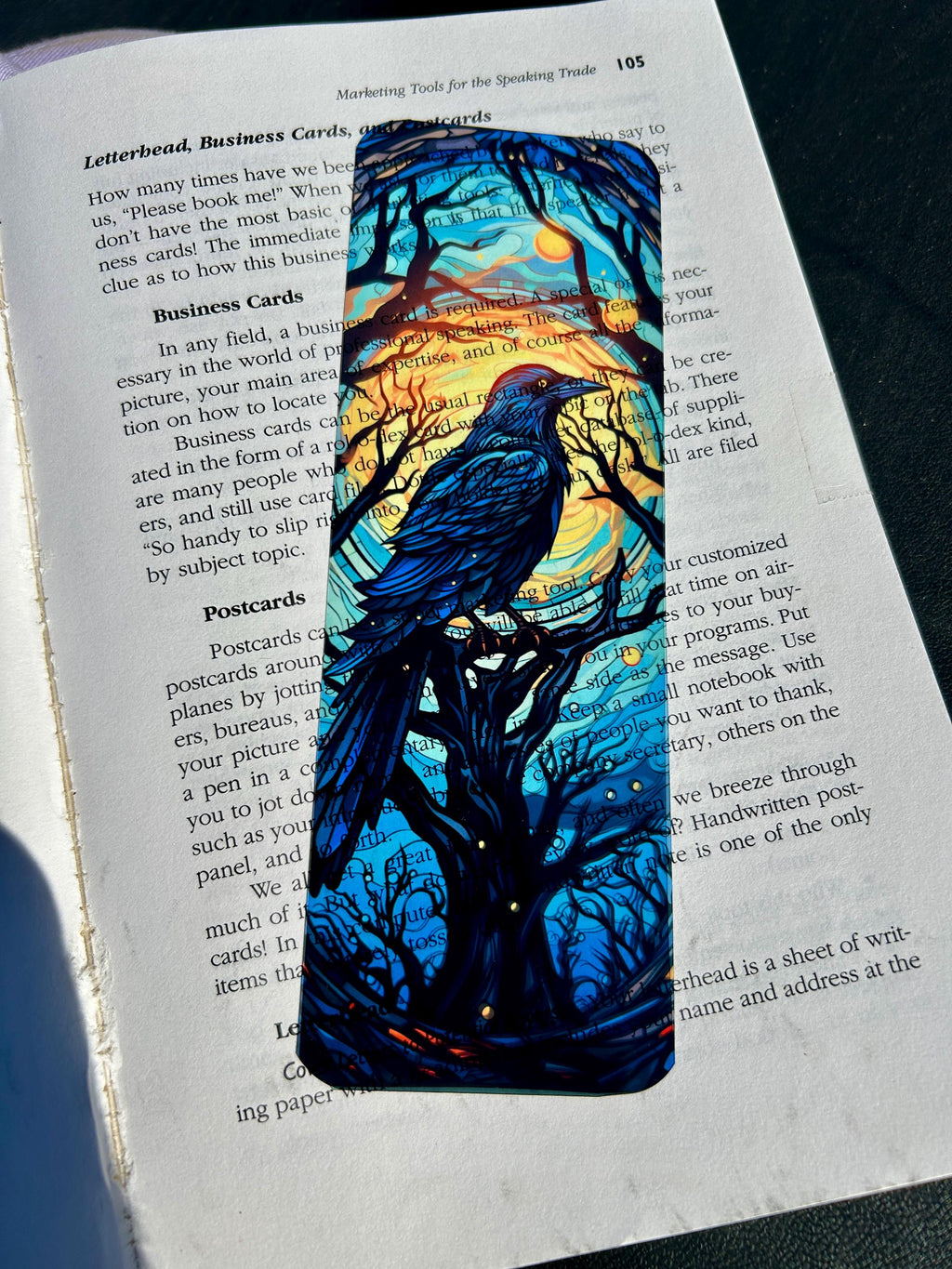 Gothic raven bookmark with stained glass arch, sunset skies and vintage pedestal, dark fantasy bird art for moody readers | | Wiccan Center